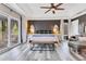 Spacious main bedroom with balcony access, dark accent wall and modern furnishings at 10142 Hidden Dunes Ln, Orlando, FL 32832