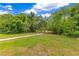 Community path through a green space, leading to a wooden bridge; perfect for walking and enjoying the natural surroundings at 10142 Hidden Dunes Ln, Orlando, FL 32832