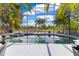 Stunning screened-in pool with serene lake views, set against lush palms offering a private, resort-like ambiance at 10142 Hidden Dunes Ln, Orlando, FL 32832