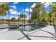 Inviting screened-in pool and spa with serene lake views, creating a relaxing outdoor oasis for entertaining or unwinding at 10142 Hidden Dunes Ln, Orlando, FL 32832