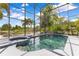 Tranquil screened-in pool with spa overlooking a serene lake, perfect for relaxation and enjoying picturesque waterfront views at 10142 Hidden Dunes Ln, Orlando, FL 32832