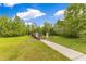 A beautiful walking path leads over a small bridge in a green community area at 10142 Hidden Dunes Ln, Orlando, FL 32832