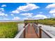 Community waterfront pavilion with a wooden walkway and scenic lake views at 10142 Hidden Dunes Ln, Orlando, FL 32832