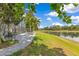 Landscaped yard with a brick patio overlooking a tranquil lake, perfect for outdoor gatherings and enjoying nature's beauty at 10142 Hidden Dunes Ln, Orlando, FL 32832