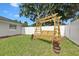 Inviting backyard featuring a charming wooden swing and lush green lawn, perfect for relaxation at 105 Spring Cove Trl, Altamonte Springs, FL 32714