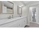 Bathroom with double sink vanity, quartz countertops, modern fixtures, and stylish mirrors at 105 Spring Cove Trl, Altamonte Springs, FL 32714