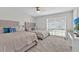 Spacious bedroom with two beds, large window, comfortable seating, and neutral decor at 105 Spring Cove Trl, Altamonte Springs, FL 32714