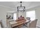Formal dining room featuring a wooden table, upholstered chairs, and decorative light fixture at 105 Spring Cove Trl, Altamonte Springs, FL 32714