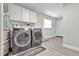 Well-equipped laundry room with washer, dryer, cabinets, and utility sink, providing convenience at 105 Spring Cove Trl, Altamonte Springs, FL 32714
