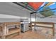 Well-equipped outdoor kitchen area with a stainless steel grill and wooden countertop space, ideal for entertaining at 105 Spring Cove Trl, Altamonte Springs, FL 32714