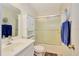 Cozy bathroom featuring a white vanity, toilet, shower/tub combo with a glass door at 107 Pamala Ct, Sanford, FL 32771