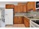Traditional kitchen featuring granite countertops, wood cabinets and stainless steel refrigerator at 107 Pamala Ct, Sanford, FL 32771