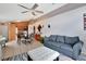 Bright living space featuring tile floors, ceiling fan, dining table, and comfortable sofas at 107 Pamala Ct, Sanford, FL 32771