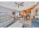 Open-concept living room with tile floors, ceiling fan, dining table, and comfortable seating at 107 Pamala Ct, Sanford, FL 32771
