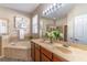 Bathroom featuring double sinks, a large mirror, a garden tub, and a separate shower at 113 Venetian Bay Cir, Sanford, FL 32771