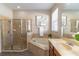 Bathroom featuring a glass enclosed shower, a large garden tub, and a window with blinds at 113 Venetian Bay Cir, Sanford, FL 32771