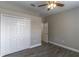 Spacious bedroom features wood look plank flooring and a ceiling fan at 113 Venetian Bay Cir, Sanford, FL 32771