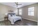 Bedroom featuring a bed with throw pillows, a ceiling fan, and two windows with blinds at 113 Venetian Bay Cir, Sanford, FL 32771