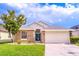 Charming single-story home with stone accents, manicured lawn, and a two-car garage at 113 Venetian Bay Cir, Sanford, FL 32771