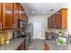 Spacious kitchen featuring stainless steel appliances, wood cabinetry and granite countertops at 113 Venetian Bay Cir, Sanford, FL 32771