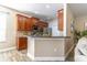 Charming kitchen showcasing wood cabinets, stainless steel appliances, and a stylish breakfast bar at 113 Venetian Bay Cir, Sanford, FL 32771