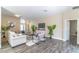 Open-concept living room with neutral tones, stylish furniture, and abundant natural light at 113 Venetian Bay Cir, Sanford, FL 32771