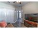 Living room including a tv, closet and view to the outdoor patio at 113 Venetian Bay Cir, Sanford, FL 32771