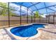Beautiful blue pool surrounded by a screened enclosure and brick pavers at 113 Venetian Bay Cir, Sanford, FL 32771
