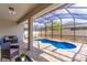 A refreshing blue pool within a screened enclosure and paved deck at 113 Venetian Bay Cir, Sanford, FL 32771