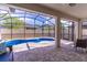 Inviting blue pool surrounded by a screened enclosure and brick pavers at 113 Venetian Bay Cir, Sanford, FL 32771