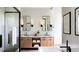 Modern bathroom featuring a double vanity, sleek mirrors, and a luxurious bathtub at 11303 Windermere Rd, Windermere, FL 34786
