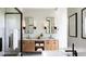 Elegant bathroom with dual sinks, wood cabinets, modern mirrors, and a glass-enclosed shower at 11303 Windermere Rd, Windermere, FL 34786