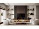 Bright and airy living room featuring modern decor, built-in shelving, and a cozy fireplace at 11303 Windermere Rd, Windermere, FL 34786