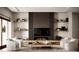 Inviting living room features a modern fireplace, floating shelves, and comfortable seating area at 11303 Windermere Rd, Windermere, FL 34786