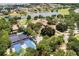 Aerial view of tennis courts, lake, pool, and clubhouse in residential neighborhood at 11415 N Camden Commons Dr, Windermere, FL 34786