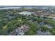 Aerial view of community playground and green space, near tree-lined street and sidewalks at 11415 N Camden Commons Dr, Windermere, FL 34786