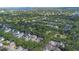 Aerial view of the community showcasing the landscaping, sidewalks and nearby lake at 11415 N Camden Commons Dr, Windermere, FL 34786