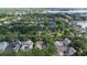 Aerial of neighborhood featuring tree-lined streets and sidewalks near a community park at 11415 N Camden Commons Dr, Windermere, FL 34786