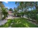 A manicured backyard features a stone walkway, lush green lawn, and privacy fence at 11415 N Camden Commons Dr, Windermere, FL 34786