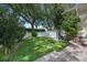 Well maintained backyard features a lush lawn with manicured landscaping and a white picket fence at 11415 N Camden Commons Dr, Windermere, FL 34786