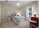 Comfortable bedroom with a plush bed, soft lighting, and a large window at 11415 N Camden Commons Dr, Windermere, FL 34786