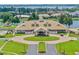 Aerial view of lavish clubhouse with pool, golf carts, and impeccable landscaping at 11415 N Camden Commons Dr, Windermere, FL 34786