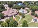 Aerial view of community center featuring a pool, tennis courts, manicured lawns, and lush trees at 11415 N Camden Commons Dr, Windermere, FL 34786
