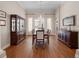Formal dining room with wood floors, built-in cabinet, large table, and elegant chandelier at 11415 N Camden Commons Dr, Windermere, FL 34786