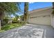 Charming home exterior with a well-manicured lawn and a two-car garage at 11415 N Camden Commons Dr, Windermere, FL 34786