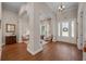 Spacious foyer featuring hardwood floors, decorative columns, and an inviting entryway at 11415 N Camden Commons Dr, Windermere, FL 34786