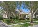 Charming home with a well-manicured lawn, mature trees, and a welcoming front porch at 11415 N Camden Commons Dr, Windermere, FL 34786