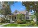 Charming single Gathering home with a inviting front porch surrounded by lush landscaping at 11415 N Camden Commons Dr, Windermere, FL 34786