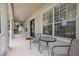 Spacious front porch with elegant columns, seating and views of the manicured lawn at 11415 N Camden Commons Dr, Windermere, FL 34786