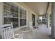 Inviting front porch with rocking chairs, perfect for enjoying the neighborhood views at 11415 N Camden Commons Dr, Windermere, FL 34786